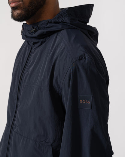 Model wearing BOSS Orange Orip Hooded Jacket in Dark Blue 404 - Detail