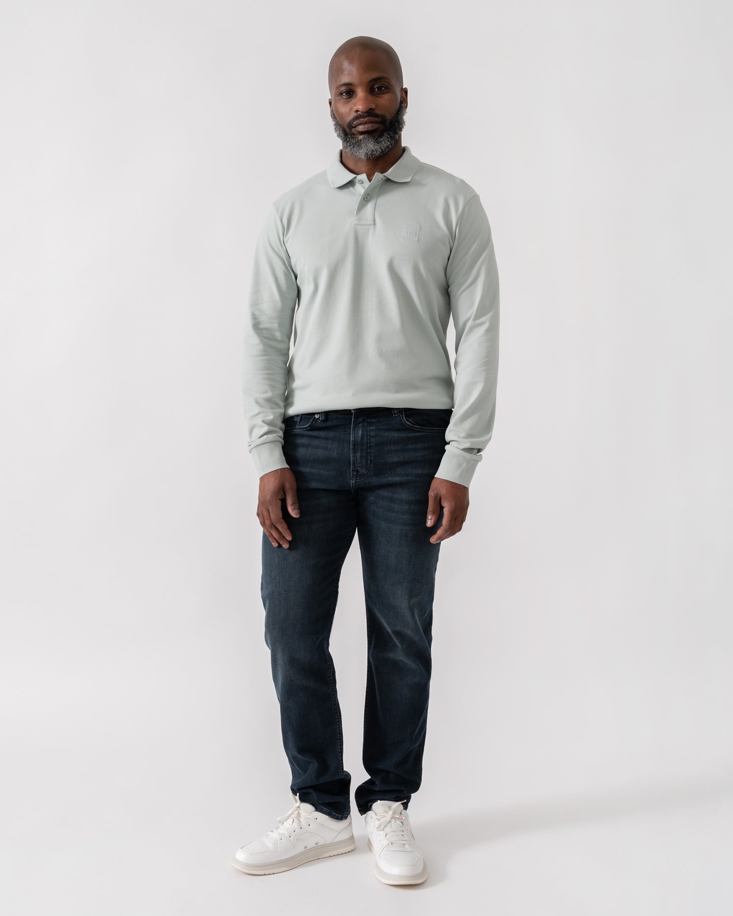 Model wearing BOSS Orange Passerby Mens Long Sleeve Stretch-Cotton Polo Shirt with Logo Patch in Silver 043 - Full Length