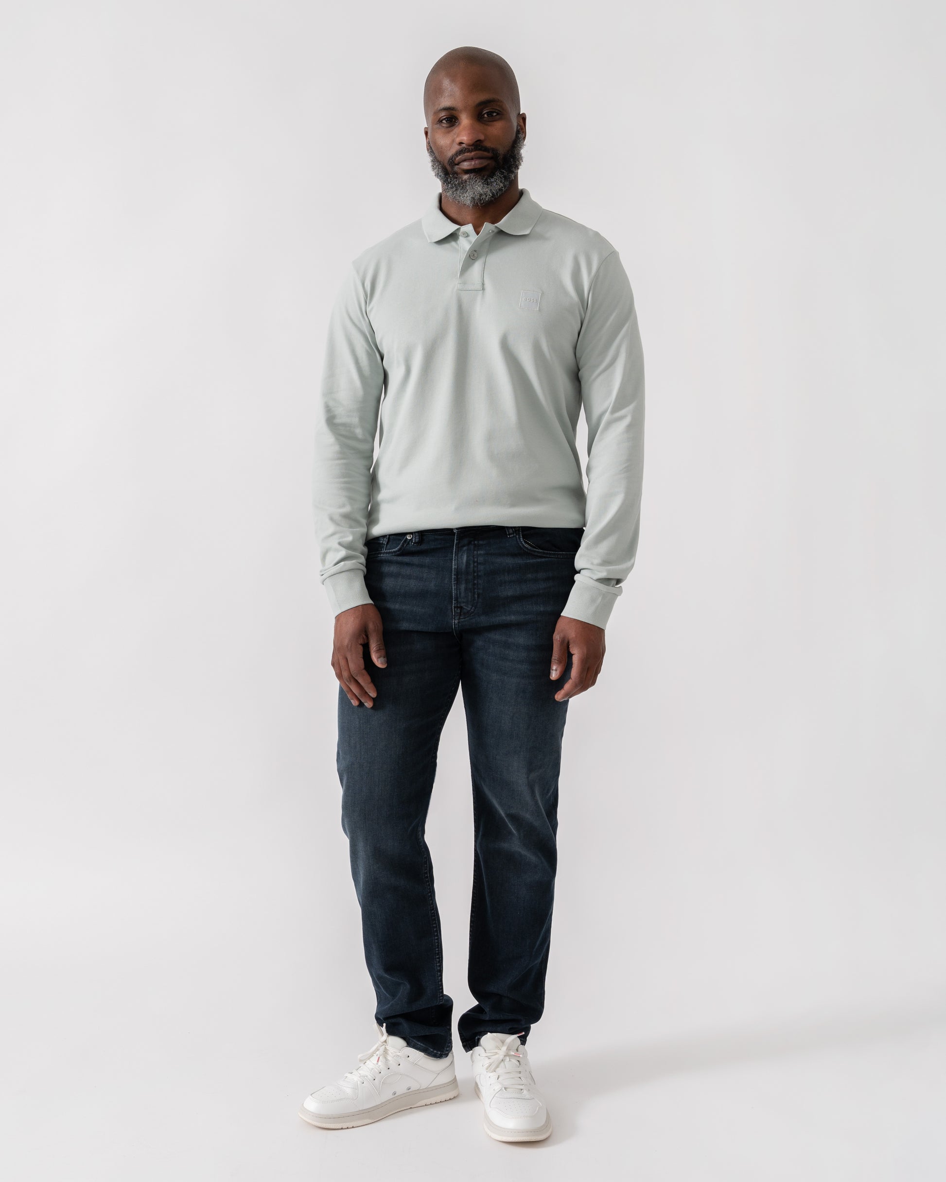 Model wearing BOSS Orange Passerby Mens Long Sleeve Stretch-Cotton Polo Shirt with Logo Patch in Silver 043 - Full Length