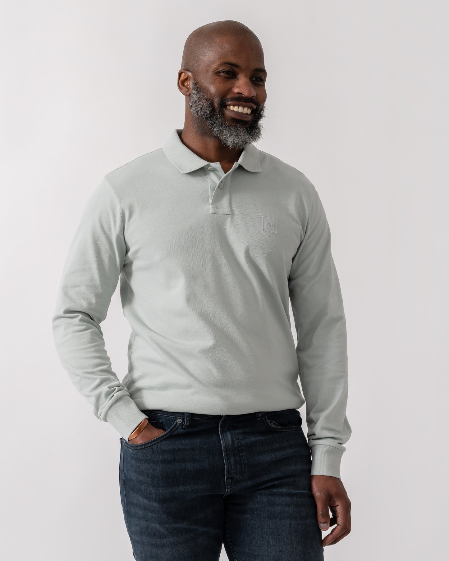 Model wearing BOSS Orange Passerby Mens Long Sleeve Stretch-Cotton Polo Shirt with Logo Patch in Silver 043 - Main