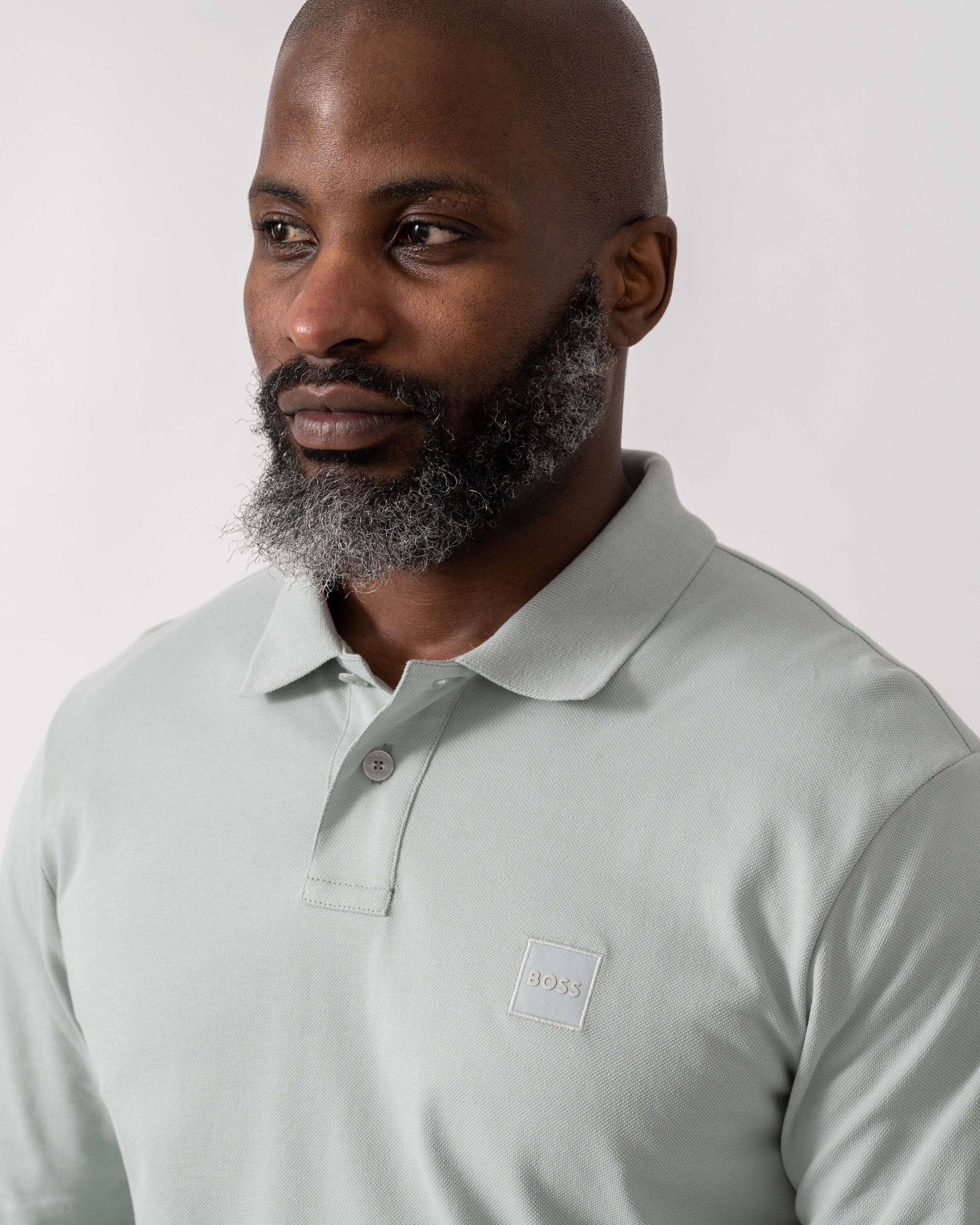 Model wearing BOSS Orange Passerby Mens Long Sleeve Stretch-Cotton Polo Shirt with Logo Patch in Silver 043 - Detail