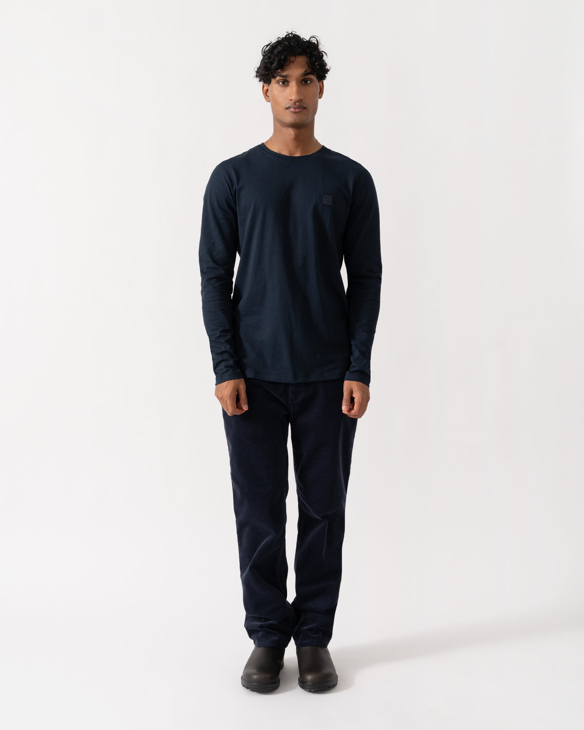 Man wearing BOSS Orange Tacks Mens Long Sleeve T-Shirt with logo Patch - Dark Blue 404