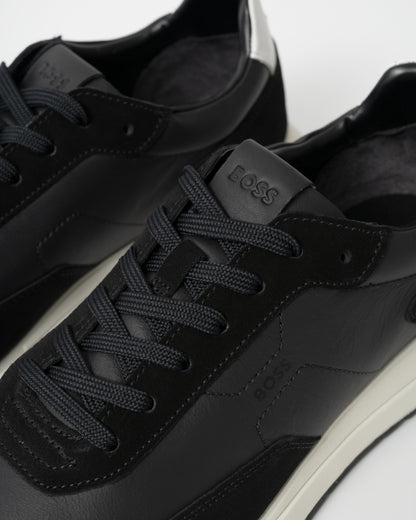 Black sneakers with 'BOSS' branding on a white background