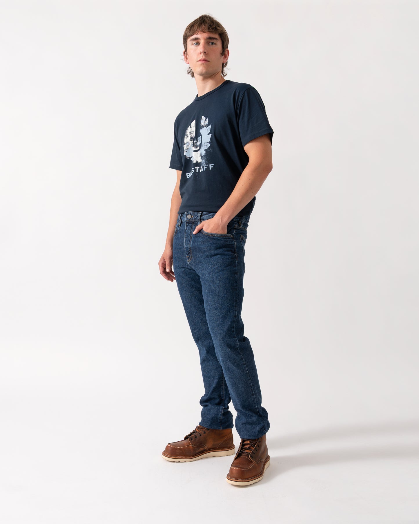 model wearing a pair of Belstaff B69 Mens Regular Fit Mid-Rise Jeans in Washed Indigo