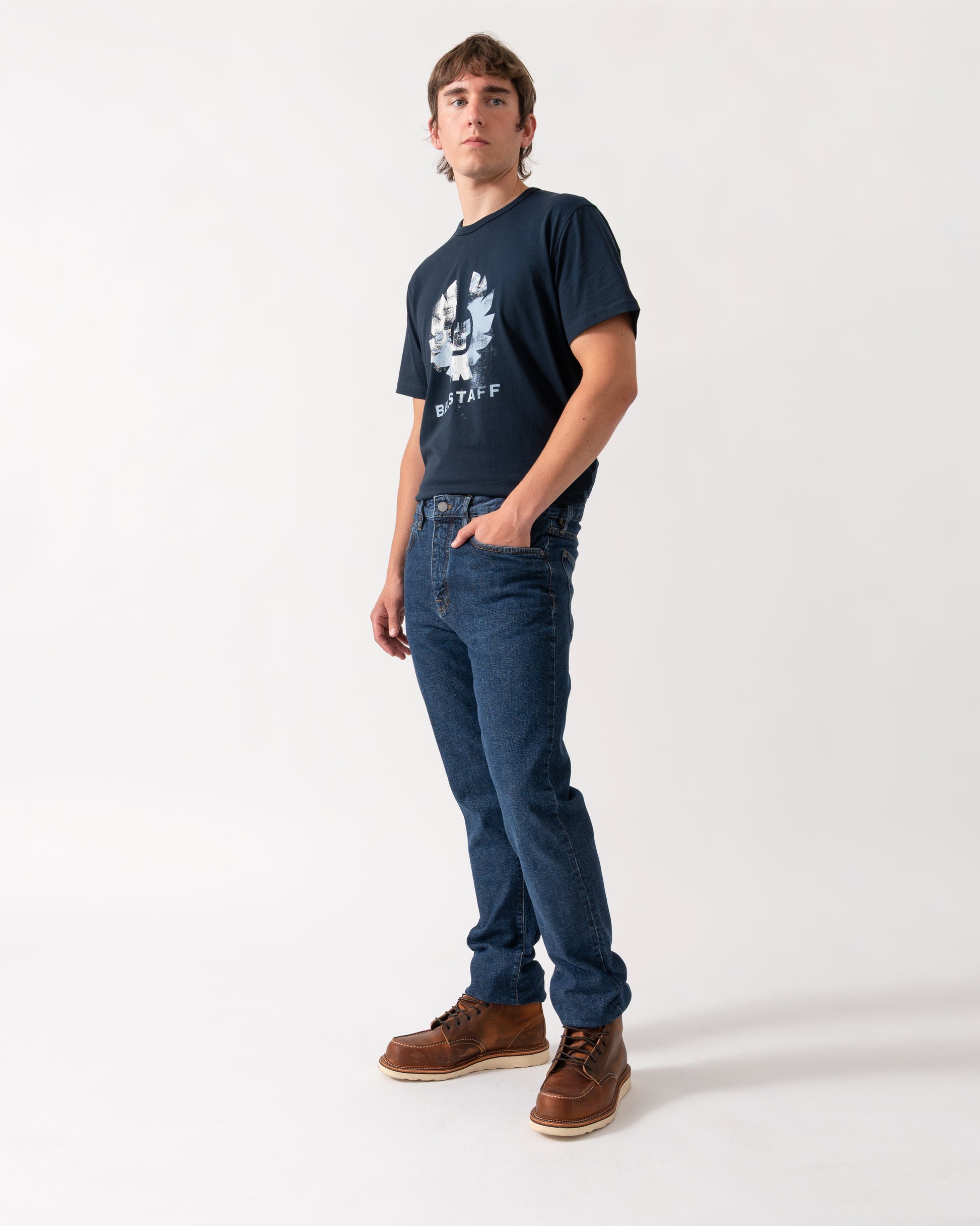 model wearing a pair of Belstaff B69 Mens Regular Fit Mid-Rise Jeans in Washed Indigo
