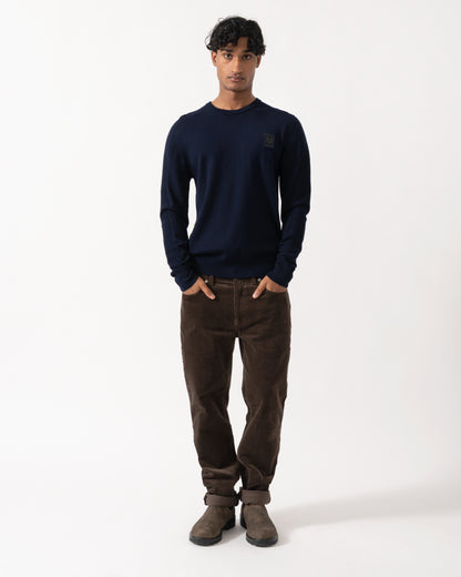 full length Studio photograph of a model wearing a Belstaff Mens Colden Merino Crew Neck Jumper in Dark Ink