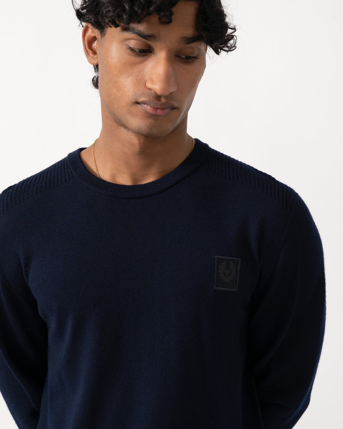 close up Studio photograph of a model wearing a Belstaff Mens Colden Merino Crew Neck Jumper in Dark Ink