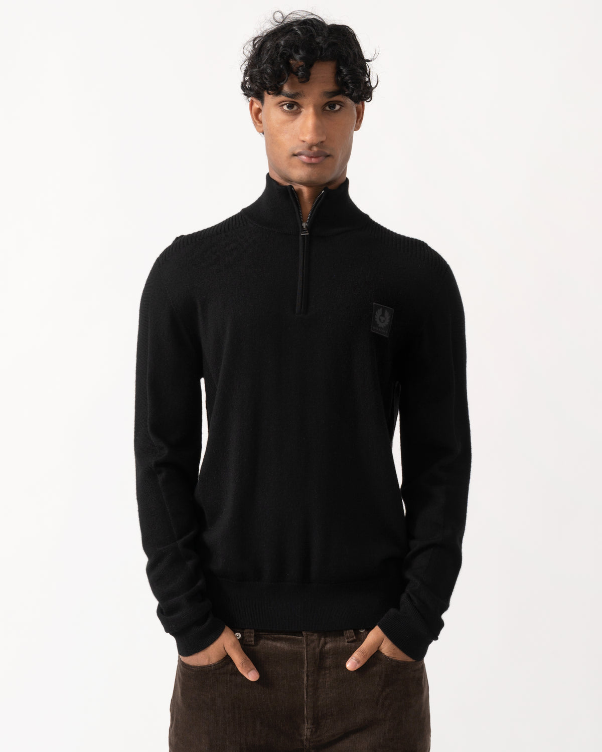 Studio photograph of a model wearing a Belstaff Mens Colden Merino Quarter Zip Jumper in Black