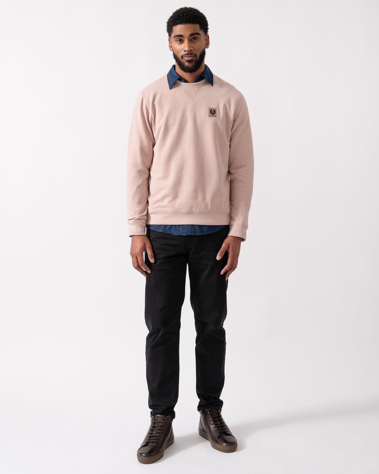 full length of a model wearing a Belstaff Mens Crew Neck Sweatshirt With Logo Patch in Dusk Pink