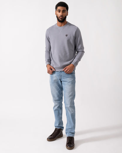 Full length shot of a Model wearing a Belstaff Mens Crew Neck Sweatshirt With Logo Patch in Faded Indigo