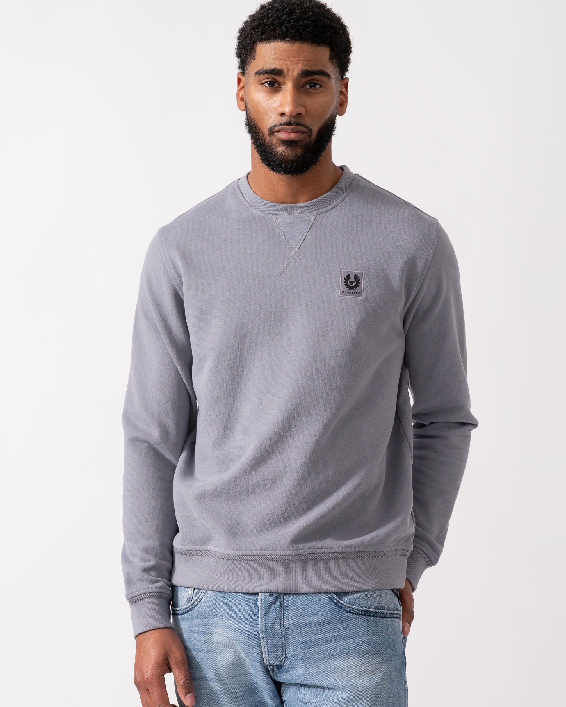 Model wearing a Belstaff Mens Crew Neck Sweatshirt With Logo Patch in Faded Indigo