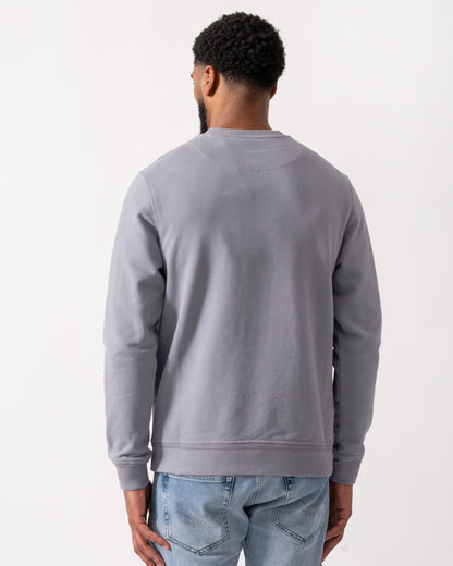 back shot of a Model wearing a Belstaff Mens Crew Neck Sweatshirt With Logo Patch in Faded Indigo
