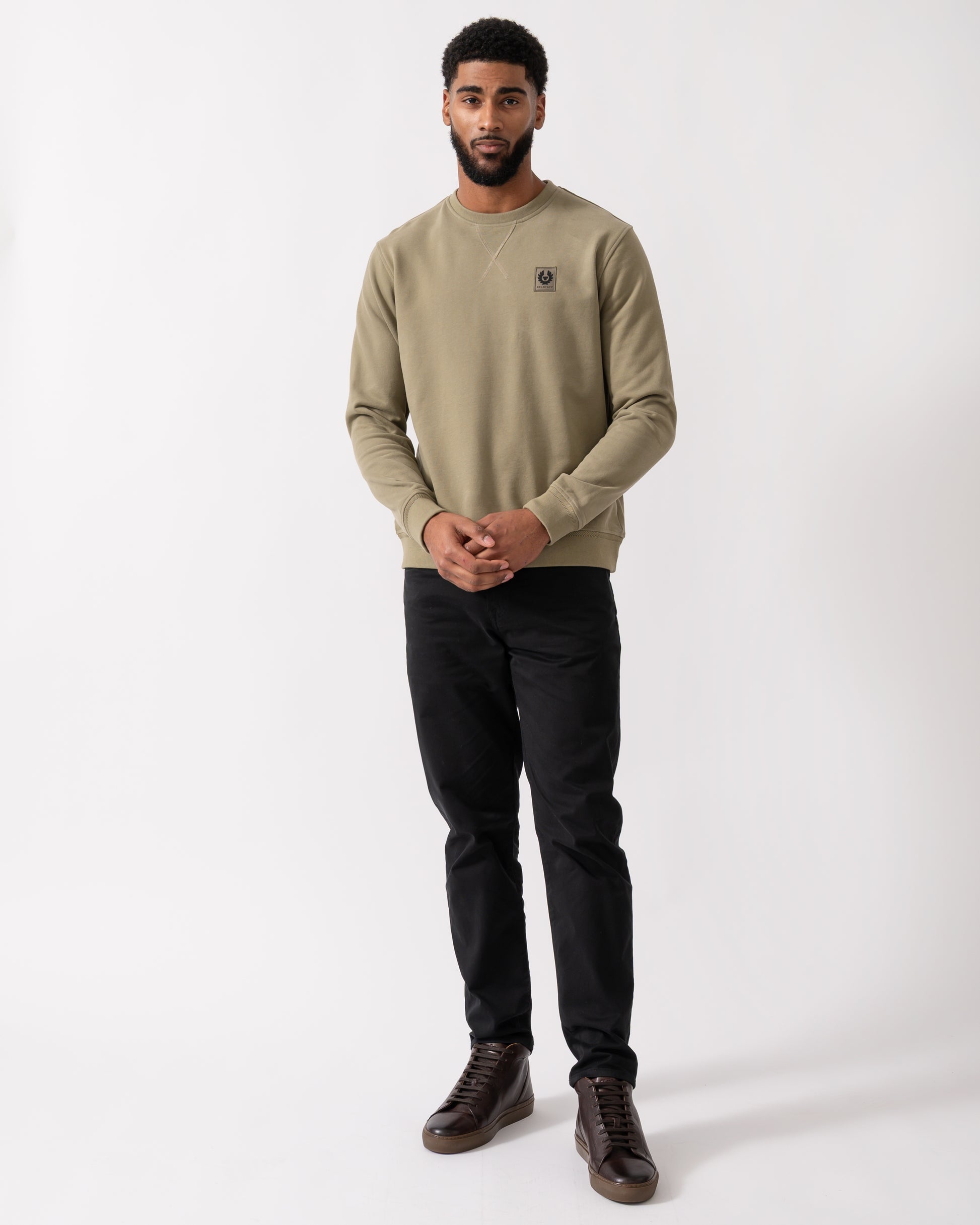 full length shot of a model wearing a Belstaff Mens Crew Neck Sweatshirt With Logo Patch in Fatigue Green