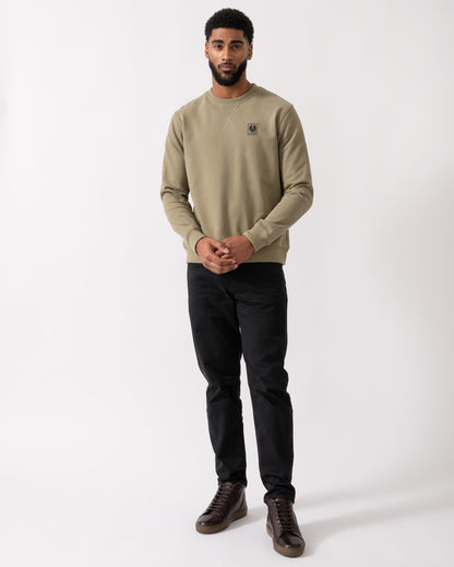 full length shot of a model wearing a Belstaff Mens Crew Neck Sweatshirt With Logo Patch in Fatigue Green