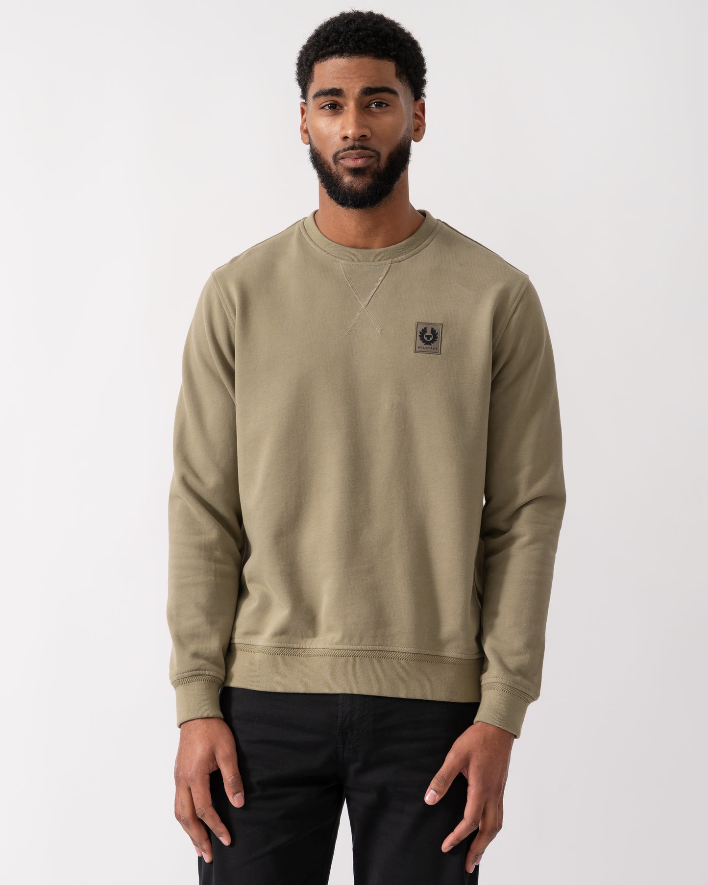 model wearing a Belstaff Mens Crew Neck Sweatshirt With Logo Patch in Fatigue Green