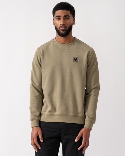 model wearing a Belstaff Mens Crew Neck Sweatshirt With Logo Patch in Fatigue Green