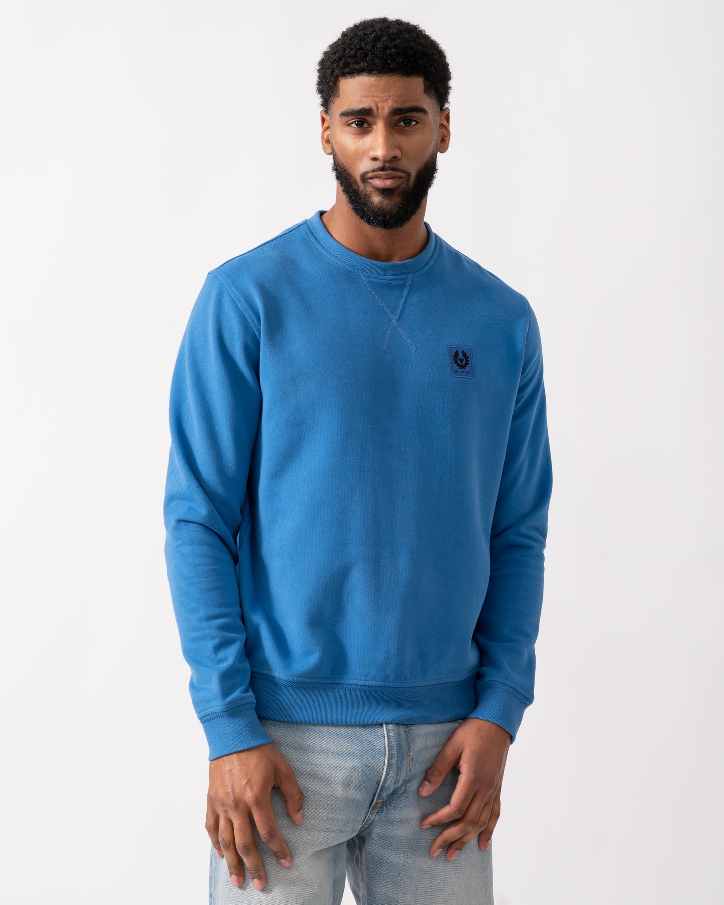 model wearing a Belstaff Mens Crew Neck Sweatshirt With Logo Patch in Marine Blue