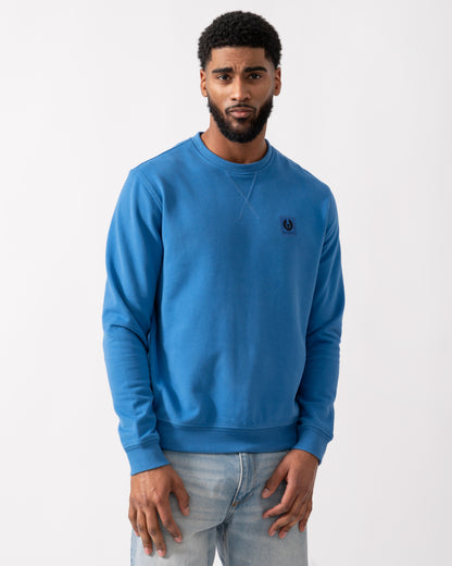 model wearing a Belstaff Mens Crew Neck Sweatshirt With Logo Patch in Marine Blue