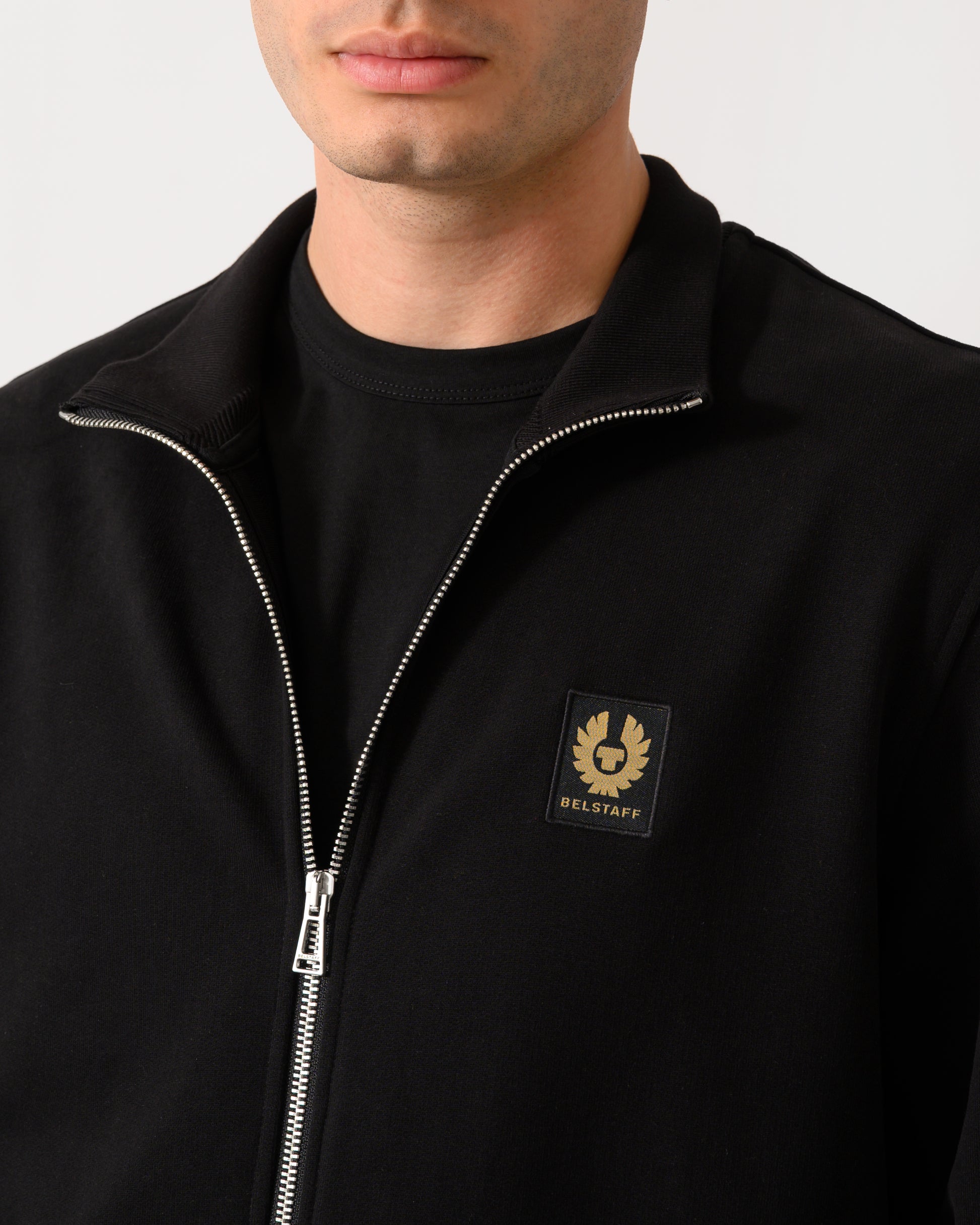 close up shot of a model wearing a Belstaff Mens Logo Full Zip Sweatshirt in Black