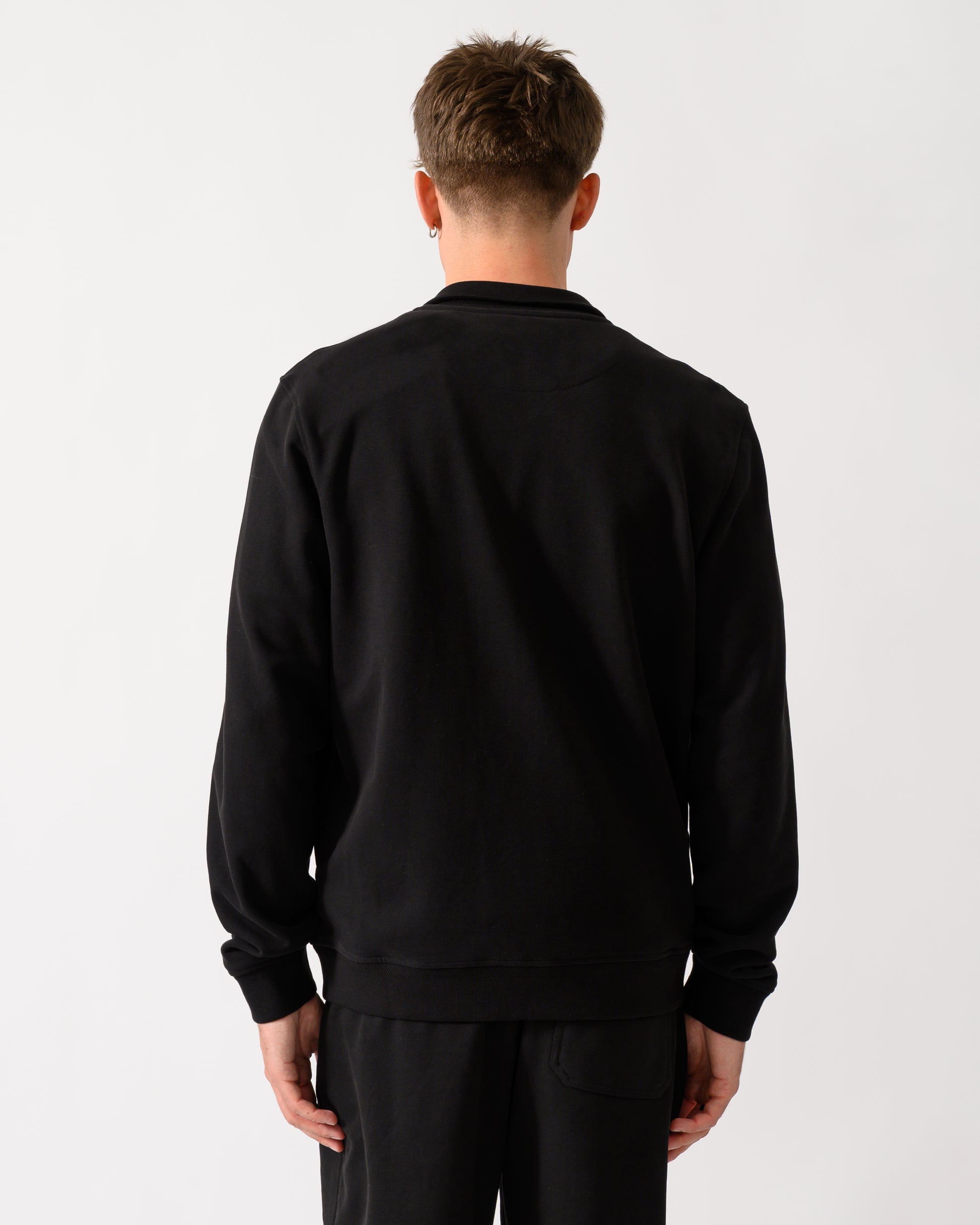back shot of a model wearing a Belstaff Mens Logo Full Zip Sweatshirt in Black