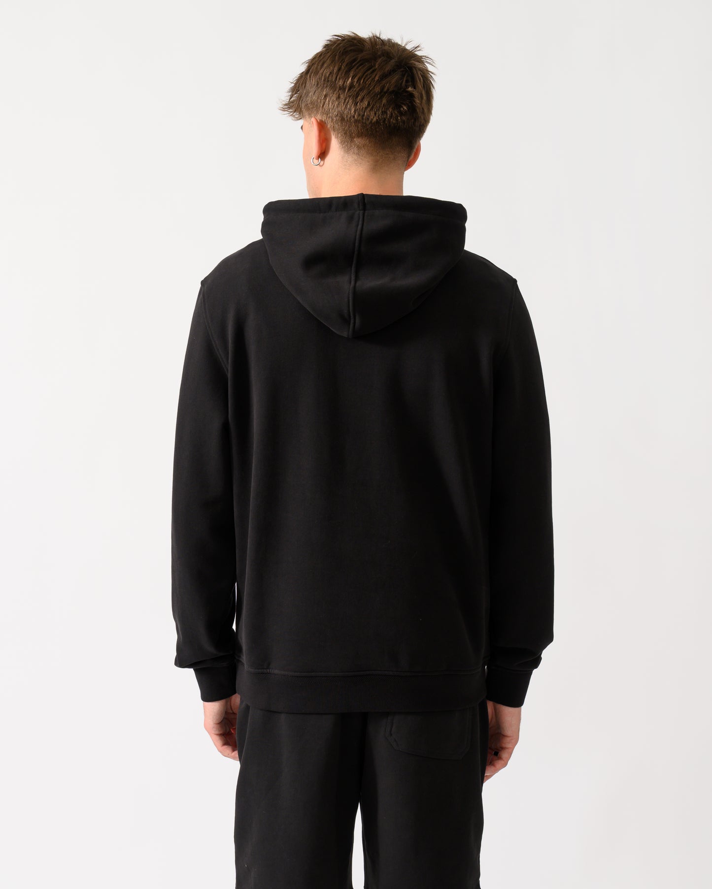 back shot of a model wearing a Belstaff Mens Logo Hoodie in Black