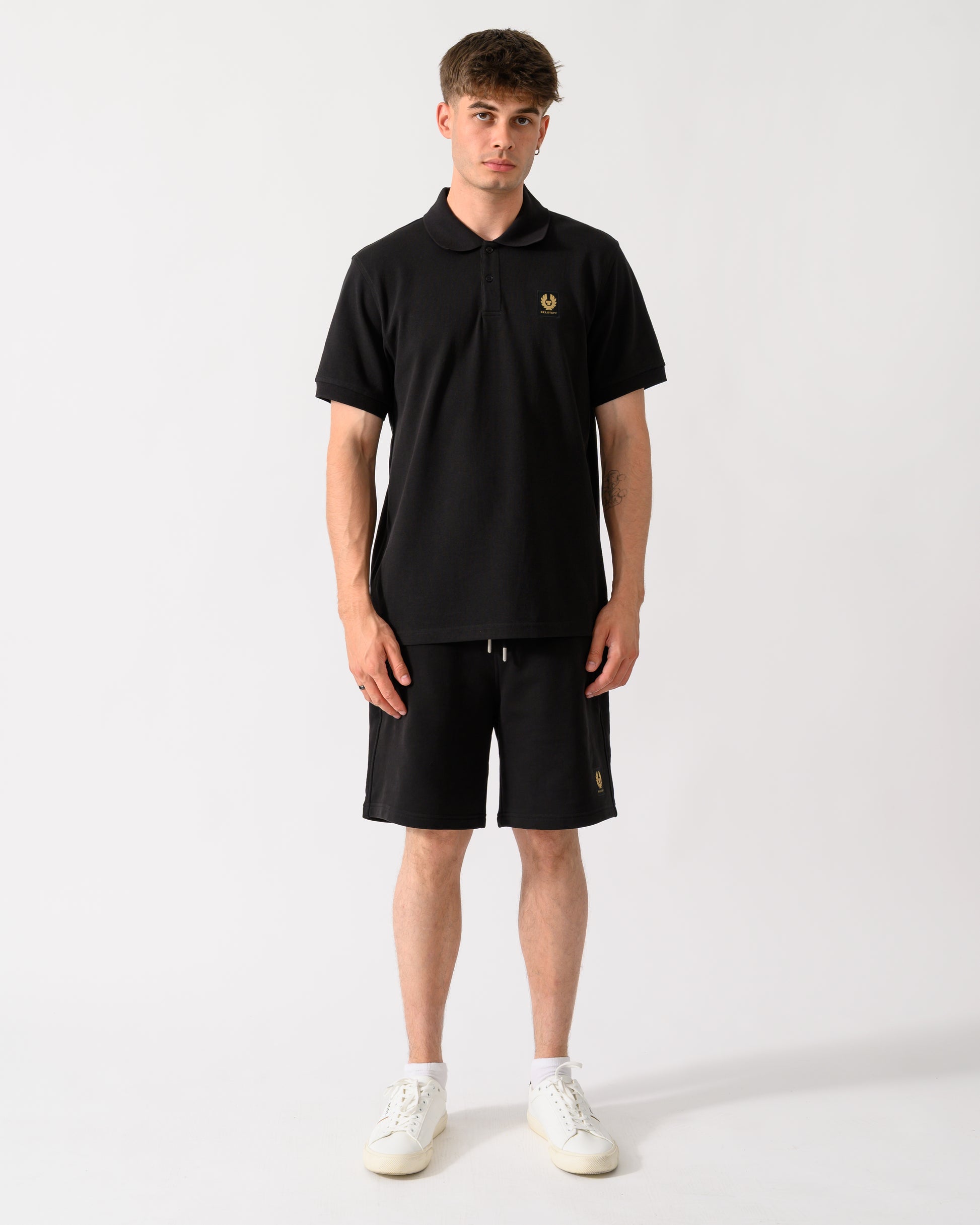 full length shot of a model wearing a Belstaff Mens Logo Polo in Black