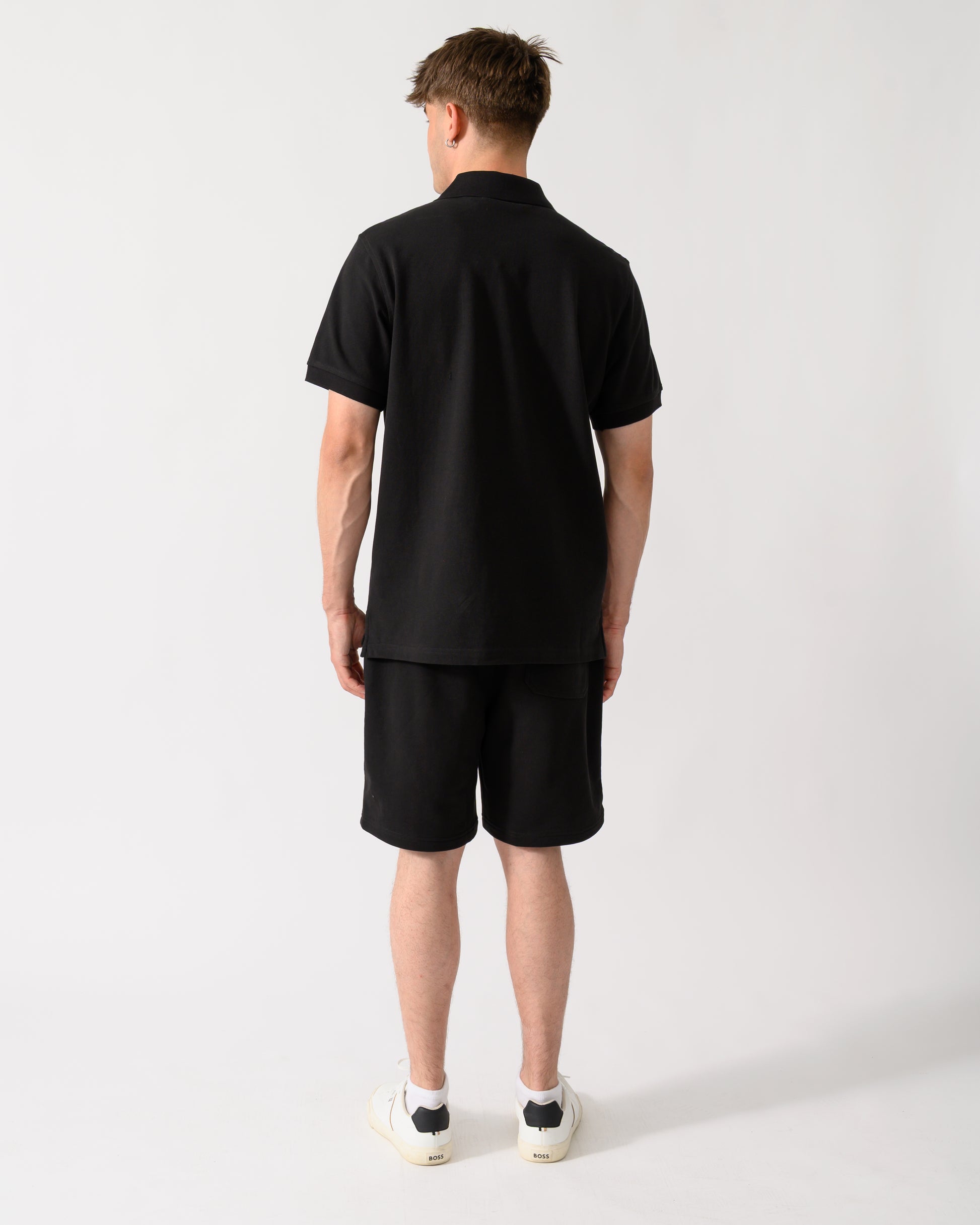 back shot of a model wearing a Belstaff Mens Logo Polo in Black