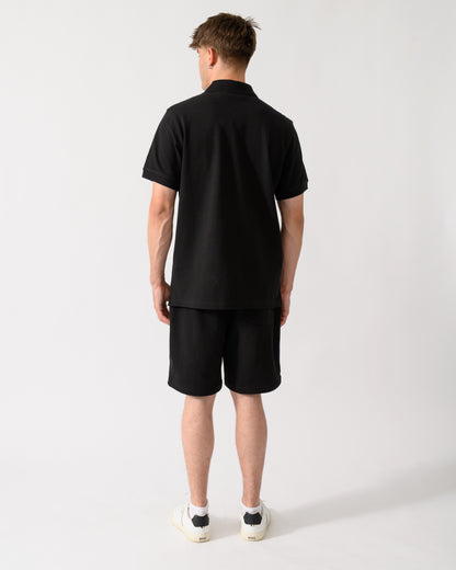 back shot of a model wearing a Belstaff Mens Logo Polo in Black