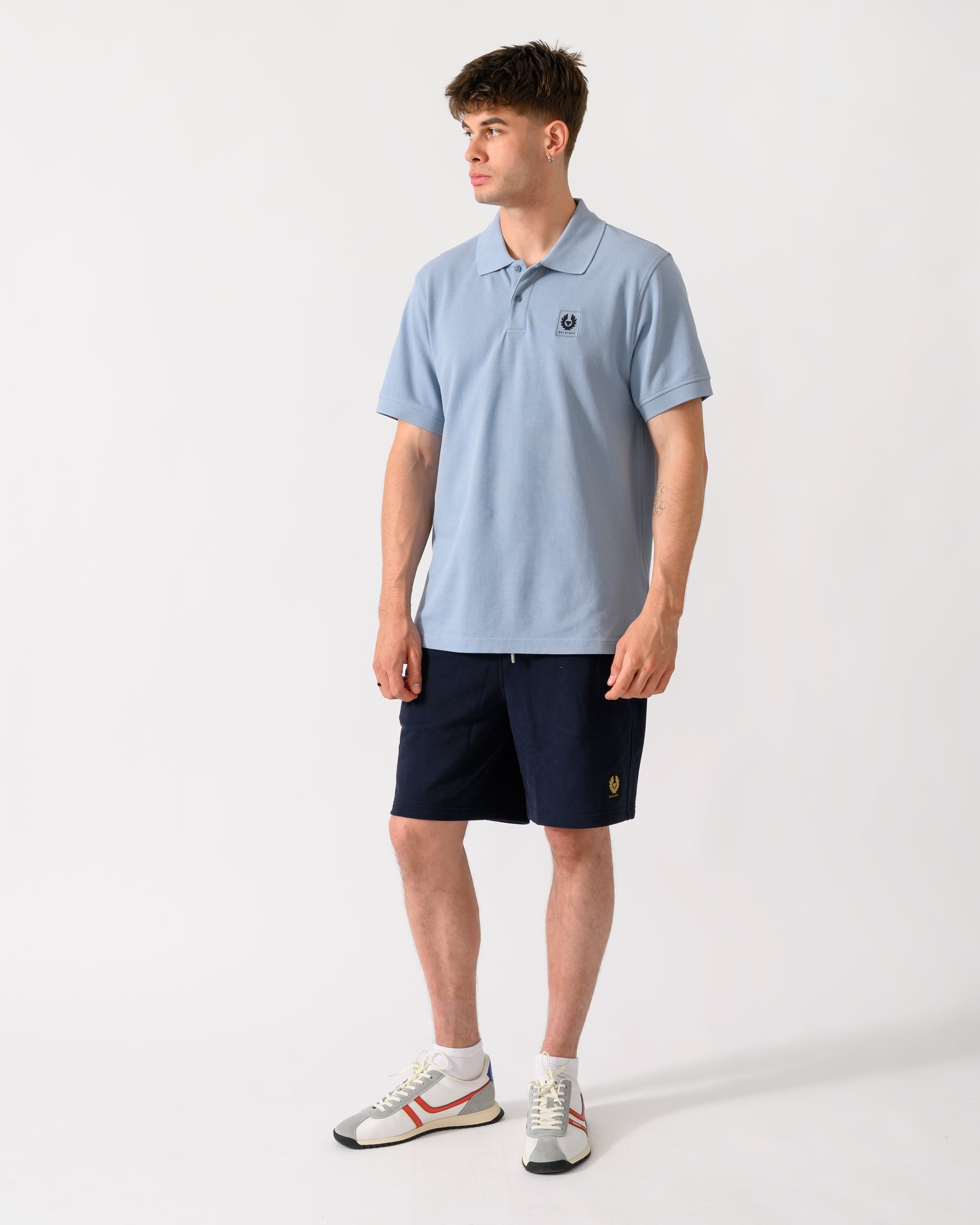 full length of a model wearing a Belstaff Mens Logo Polo in Mist Blue