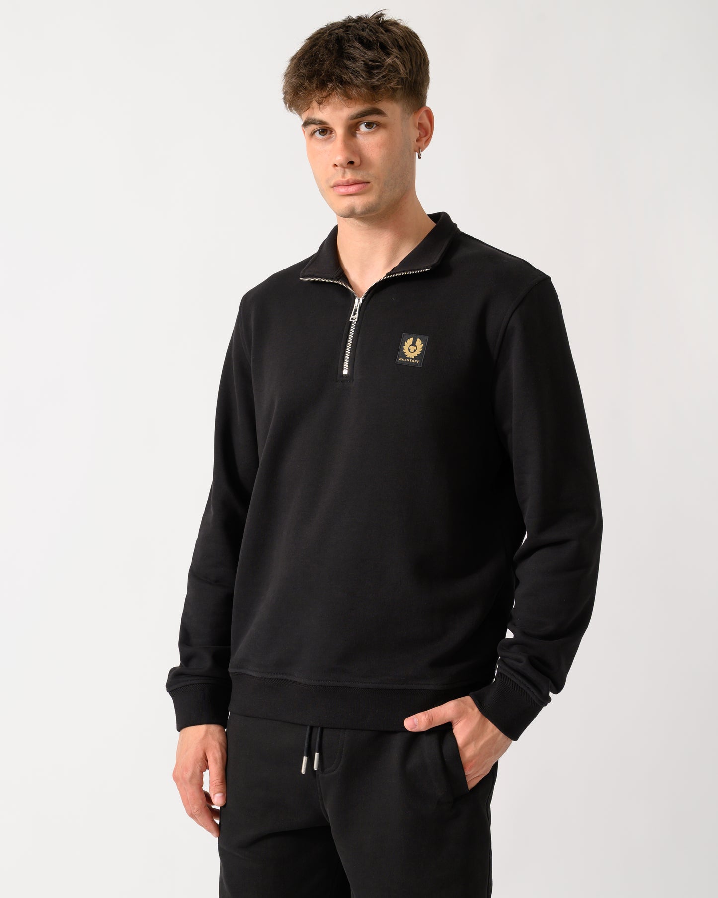 model wearing a Belstaff Mens Logo Quarter Zip Sweatshirt in Black