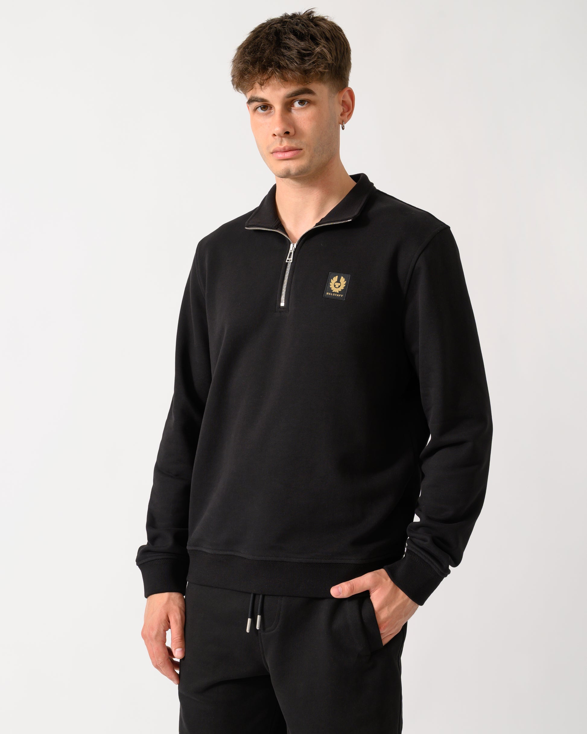 model wearing a Belstaff Mens Logo Quarter Zip Sweatshirt in Black