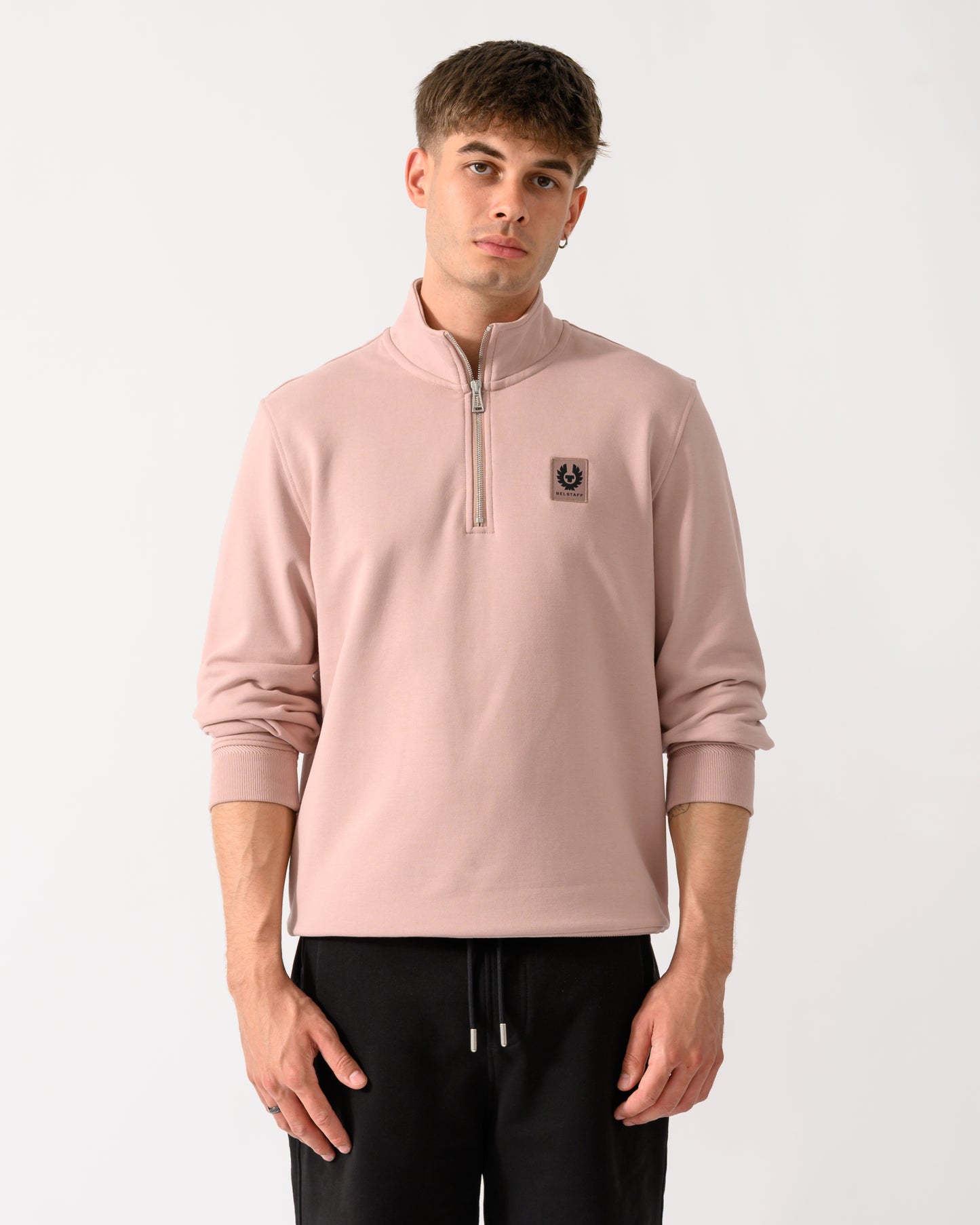 model wearing a Belstaff Mens Logo Quarter Zip Sweatshirt in Dusk Pink