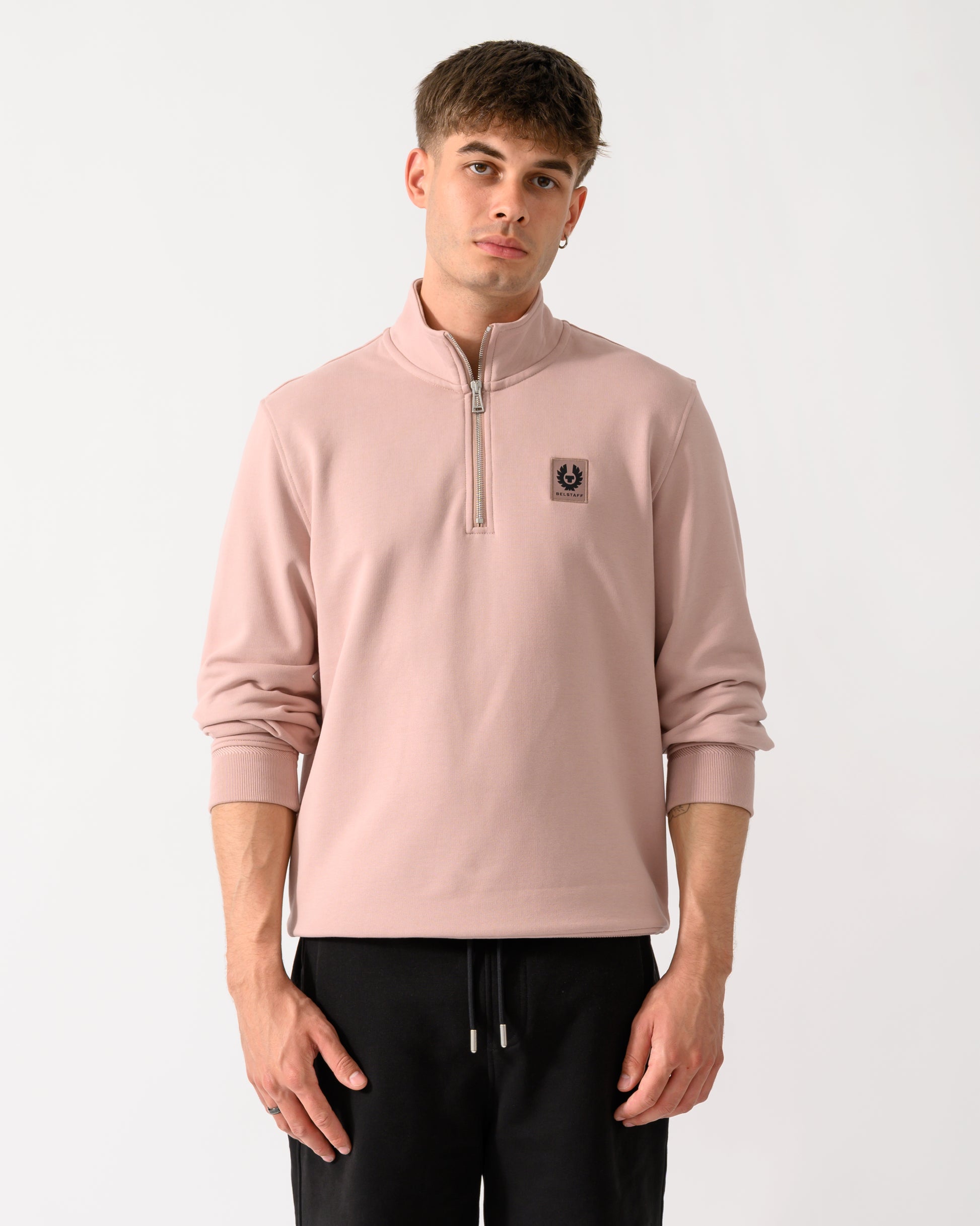 model wearing a Belstaff Mens Logo Quarter Zip Sweatshirt in Dusk Pink