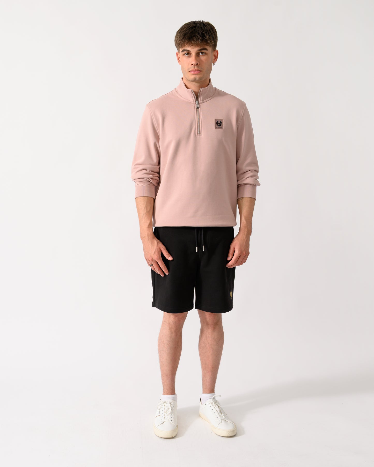 full length shot of a model wearing a Belstaff Mens Logo Quarter Zip Sweatshirt in Dusk Pink