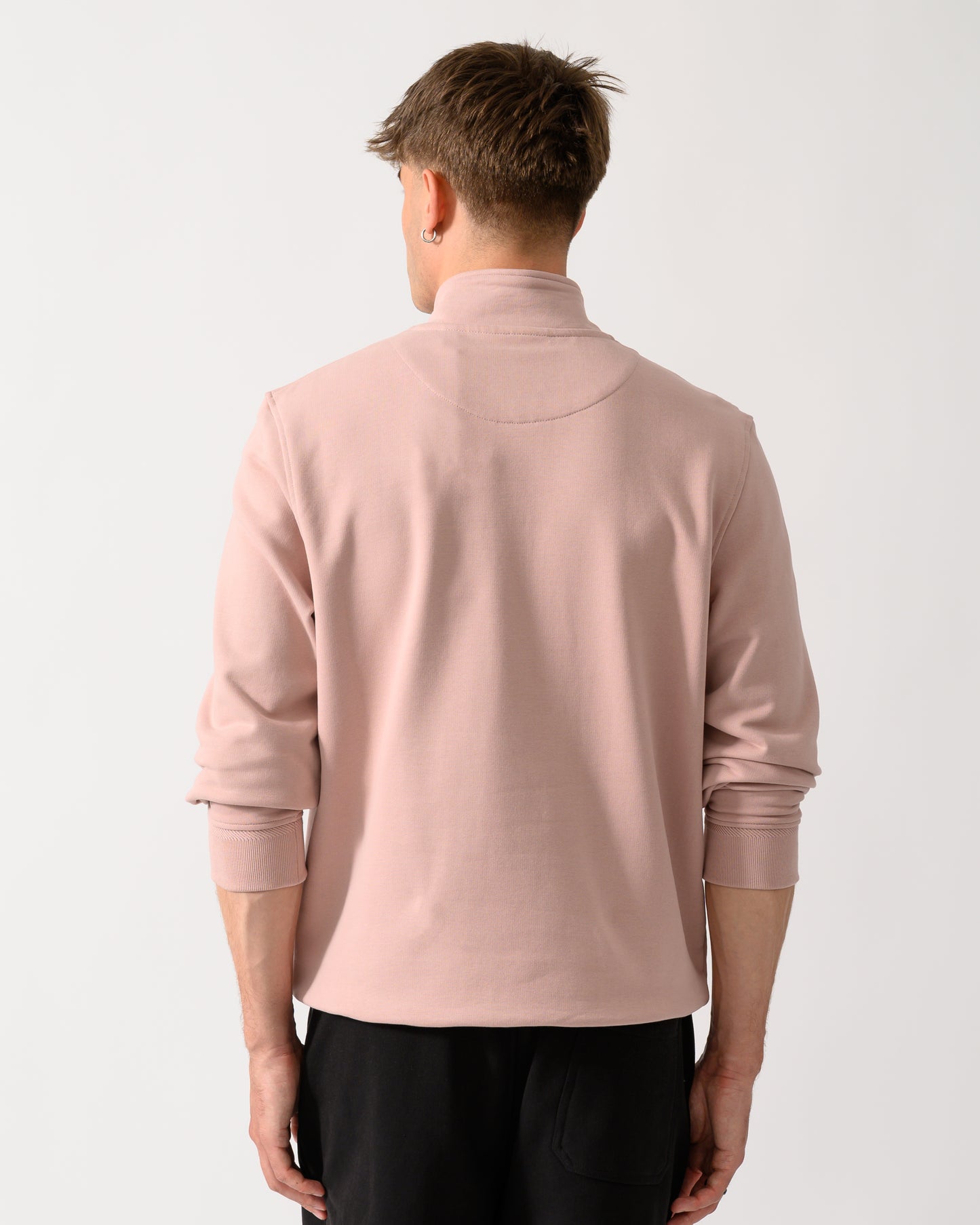 back shot of a model wearing a Belstaff Mens Logo Quarter Zip Sweatshirt in Dusk Pink