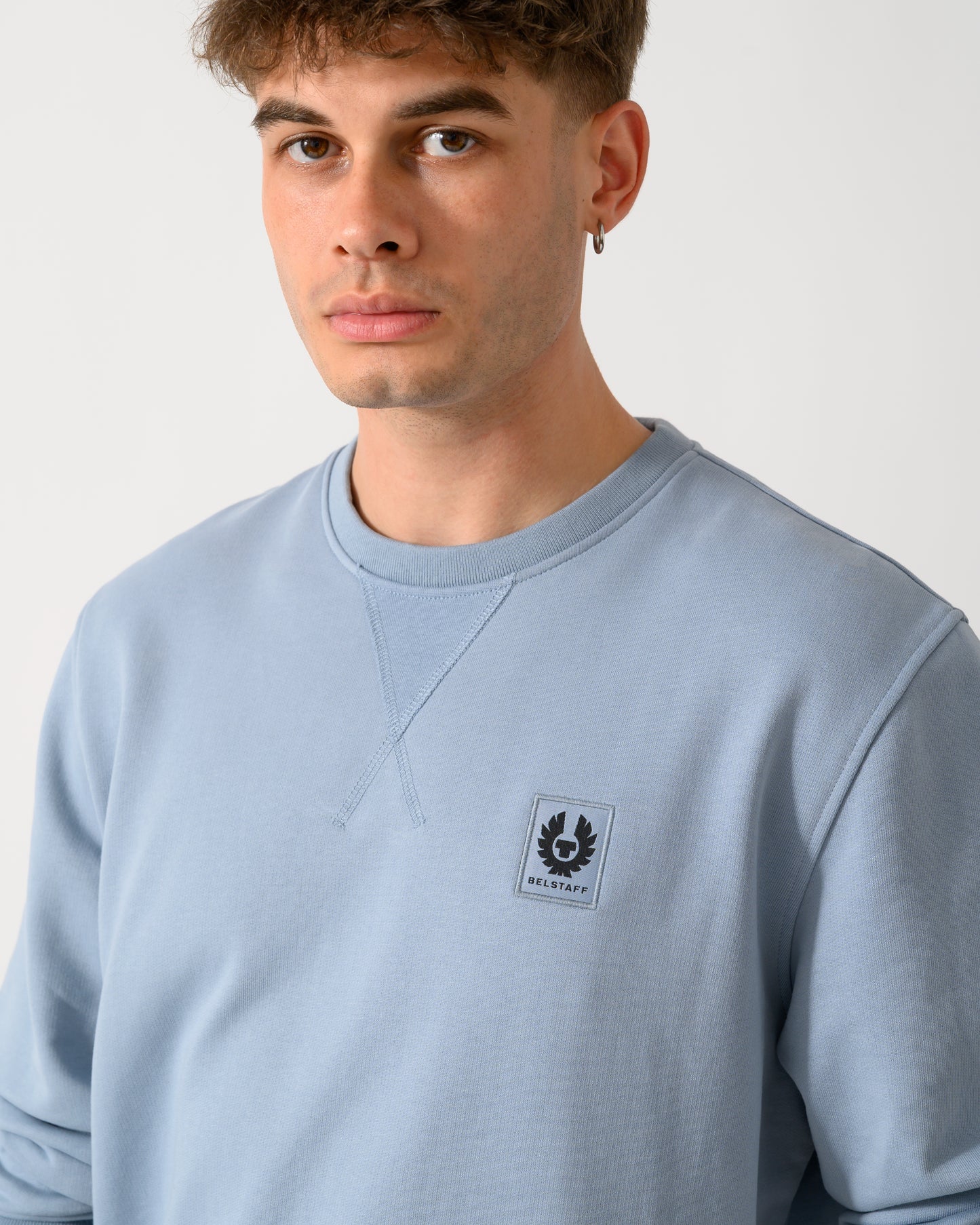 close up shot of a model wearing a Belstaff Mens Logo Sweatshirt in Mist Blue