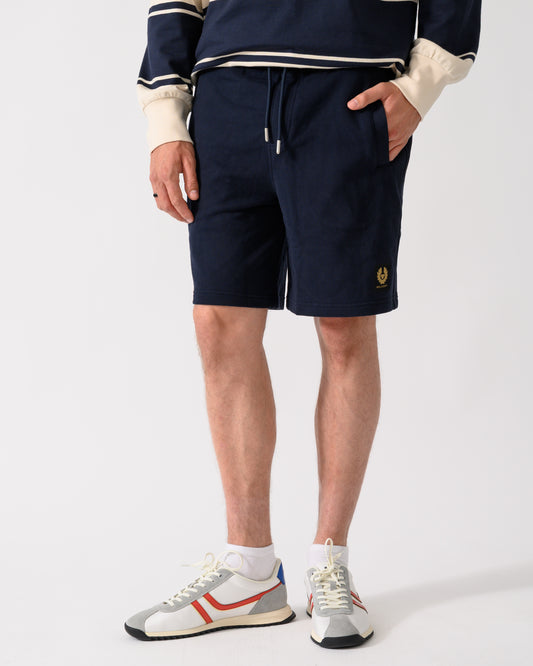 model wearing a pair of Belstaff Mens Logo Sweatshorts in Dark Ink