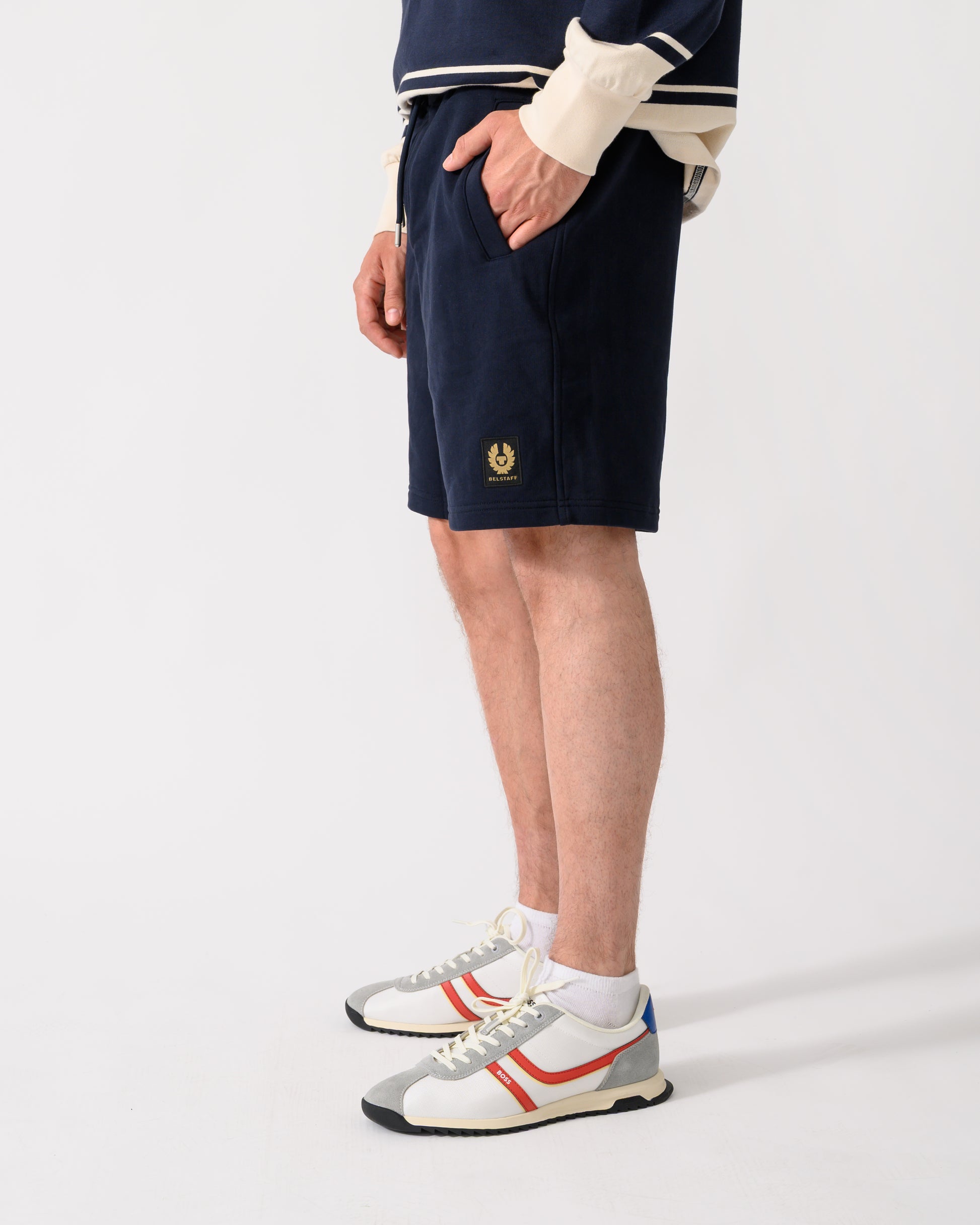 shot of model wearing a pair of Belstaff Mens Logo Sweatshorts in Dark Ink