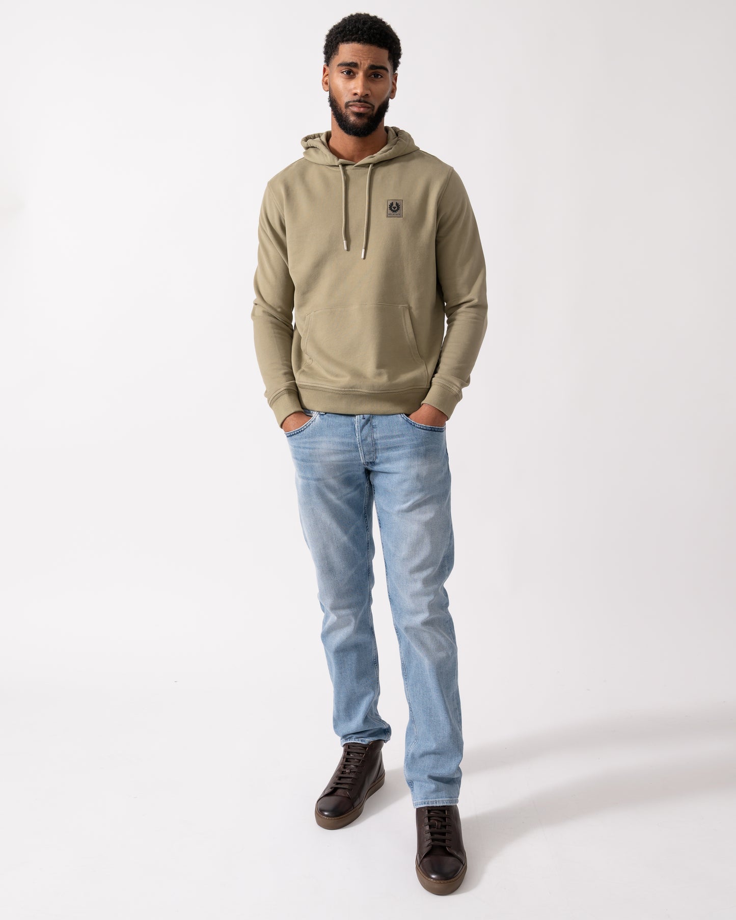 Full length shot of a Model wearing a Belstaff Mens Pullover Logo Patch Hoodie in Fatigue Green