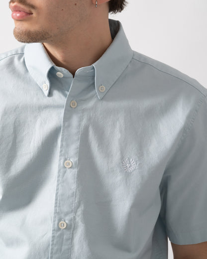 detail shot of a model wearing a Belstaff Mens Short Sleeve Street Shirt in Sky Blue