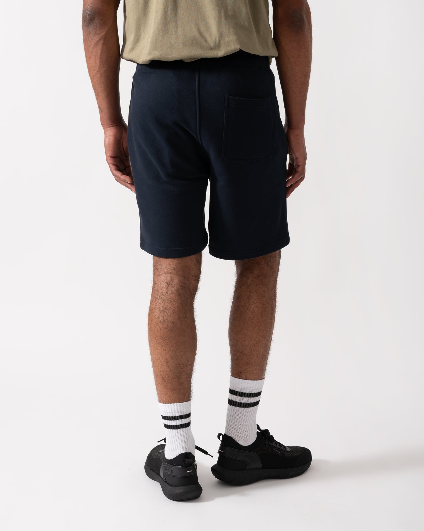 Back shot of a Model wearing a Belstaff Mens Sweatshorts in Dark Ink