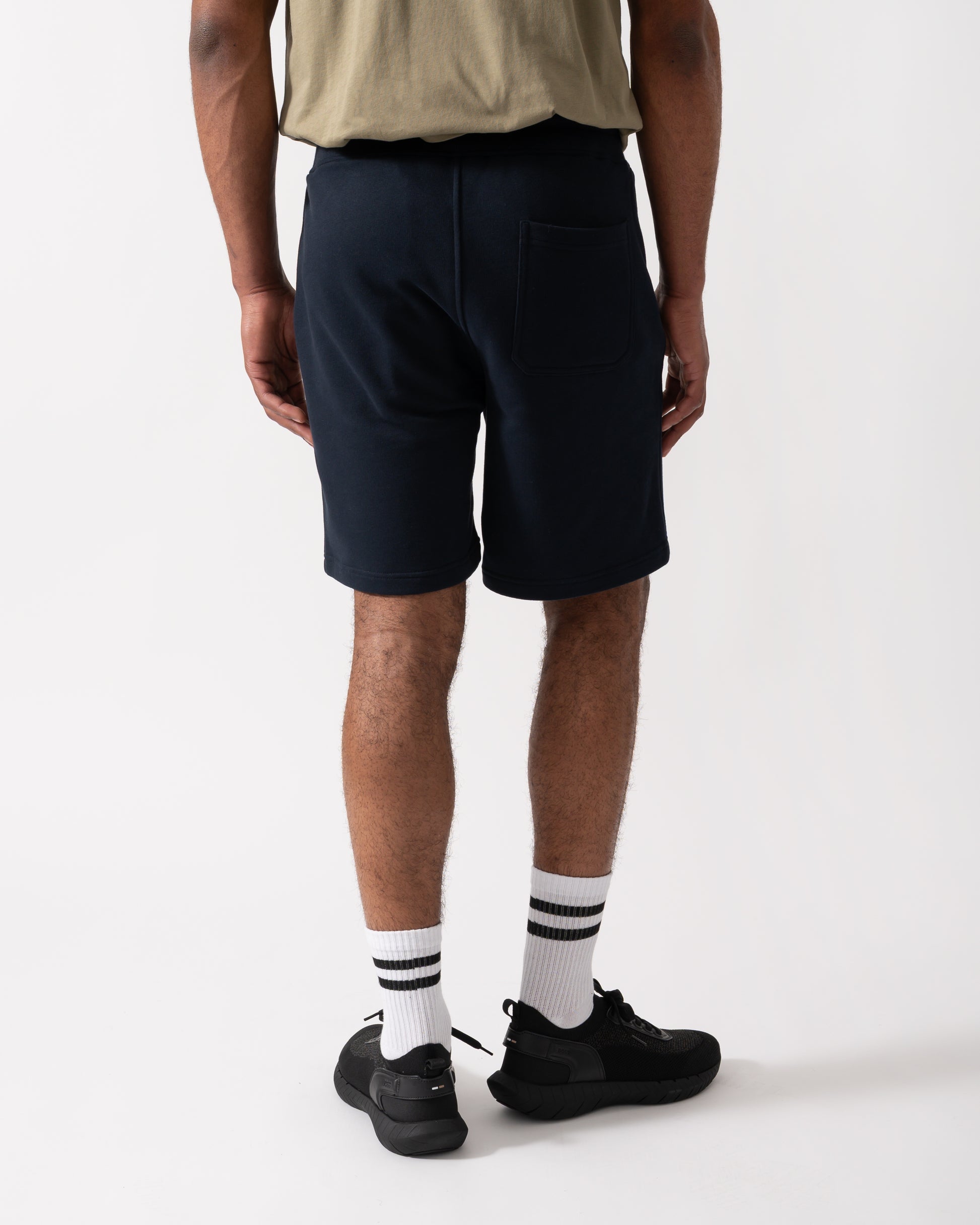 Back shot of a Model wearing a Belstaff Mens Sweatshorts in Dark Ink