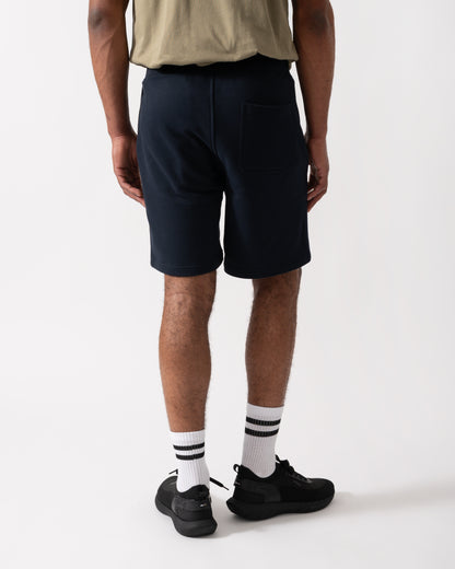 Back shot of a Model wearing a Belstaff Mens Sweatshorts in Dark Ink