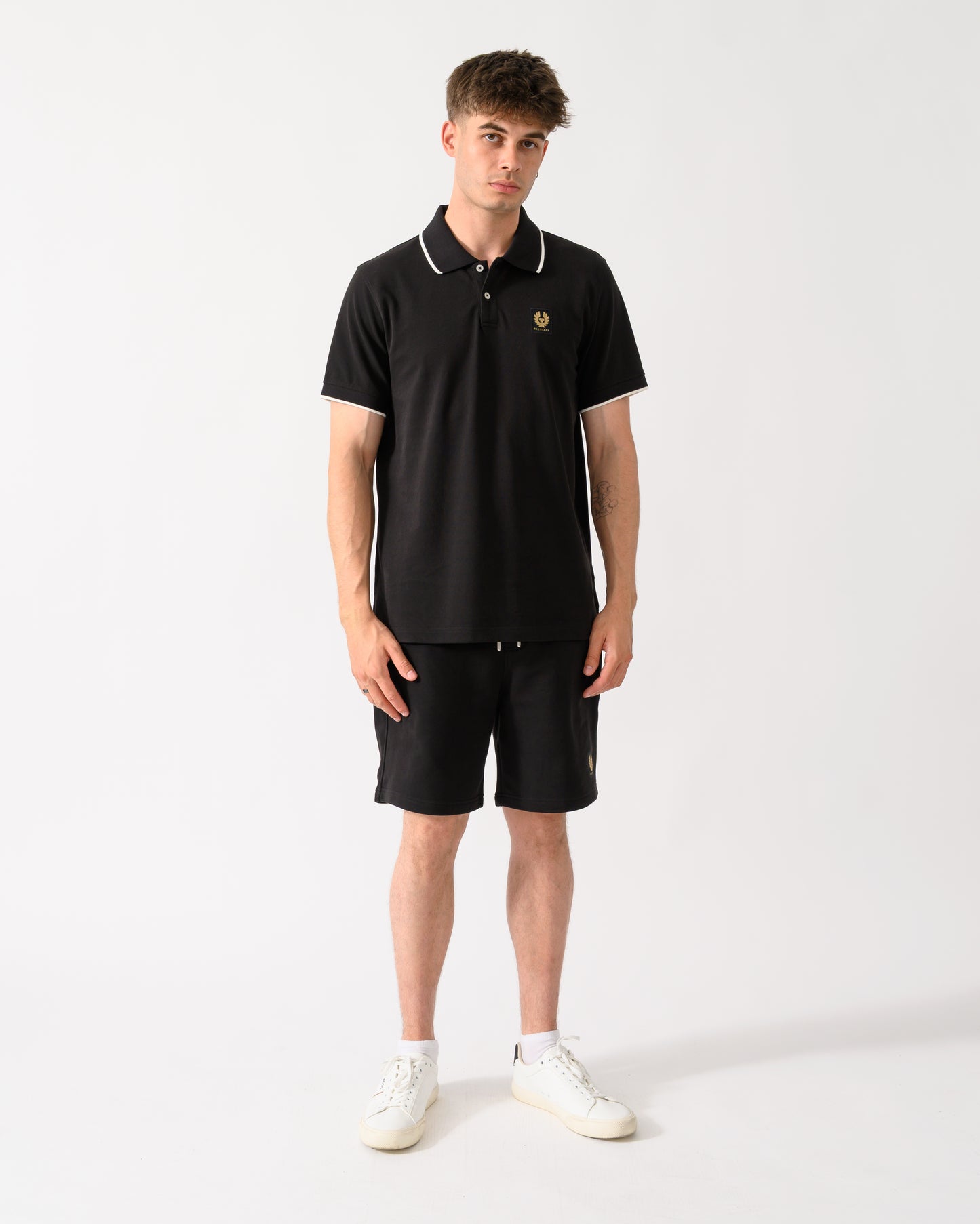 full length shot of a model wearing a Belstaff Mens Tipped Polo Shirt in Black
