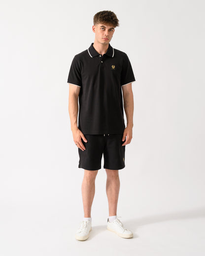 full length shot of a model wearing a Belstaff Mens Tipped Polo Shirt in Black