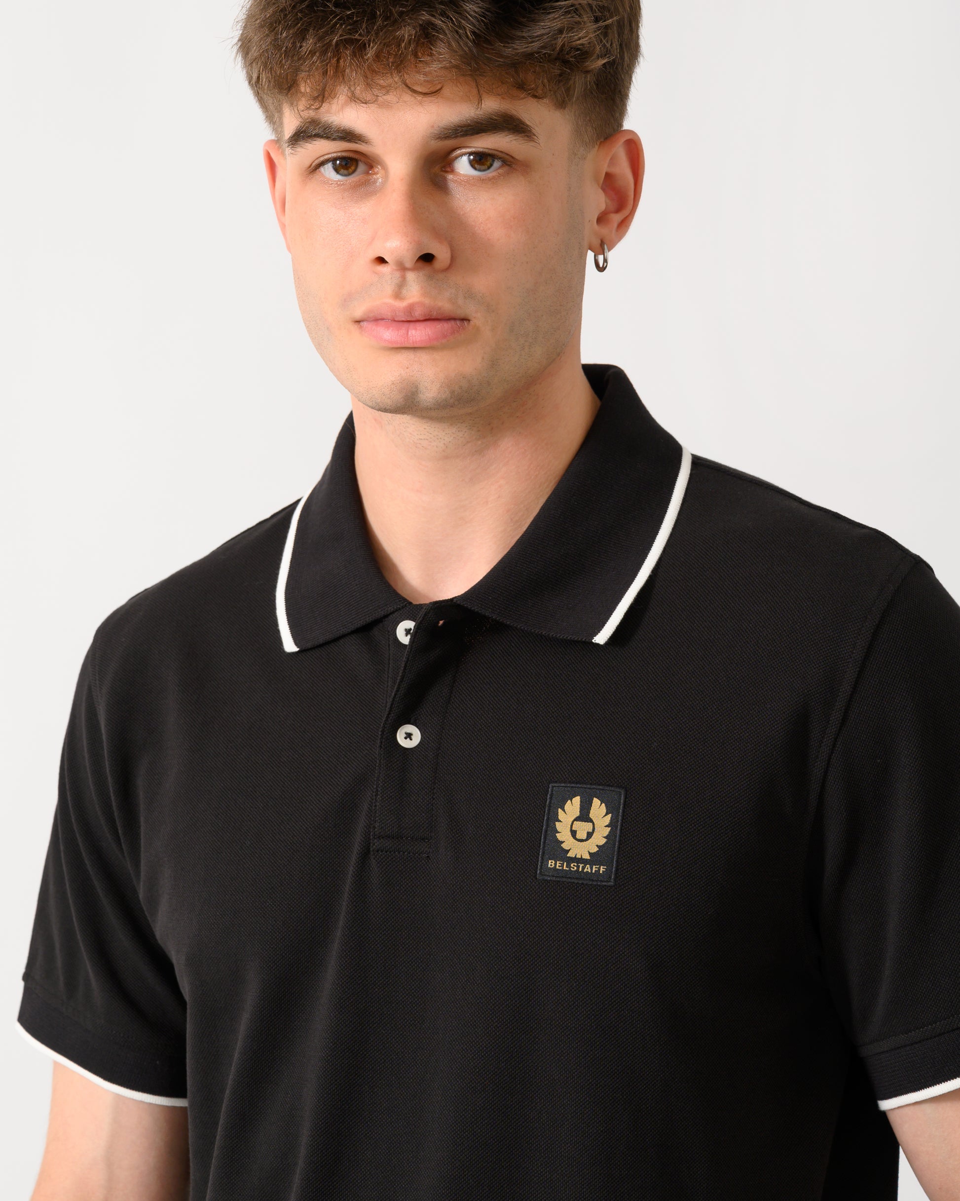 close up shot of a model wearing a Belstaff Mens Tipped Polo Shirt in Black