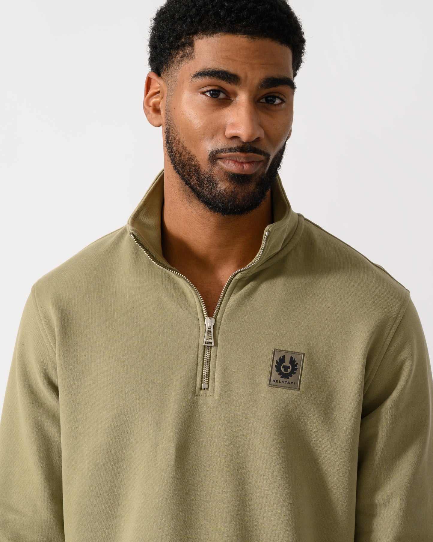 Detail shot of a Model wearing a Belstaff Quarter Zip Sweatshirt in Fatigue Green