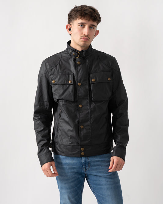 Studio shot of a model wearing a Belstaff Racemaster Mens Waxed Cotton Compact Field Jacket in Dark Navy