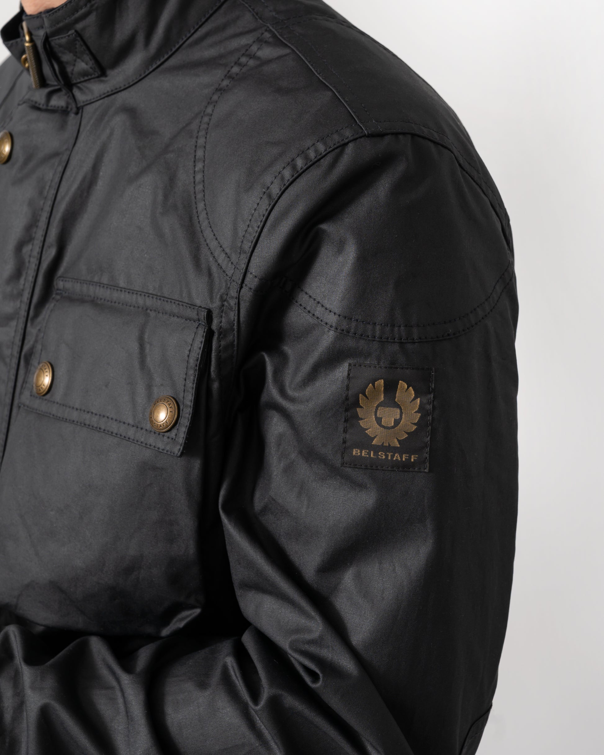 logo detail of a Belstaff Racemaster Mens Waxed Cotton Compact Field Jacket in Dark Navy