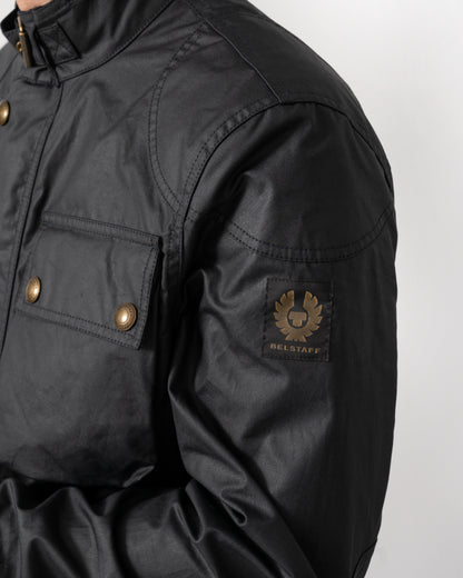 logo detail of a Belstaff Racemaster Mens Waxed Cotton Compact Field Jacket in Dark Navy